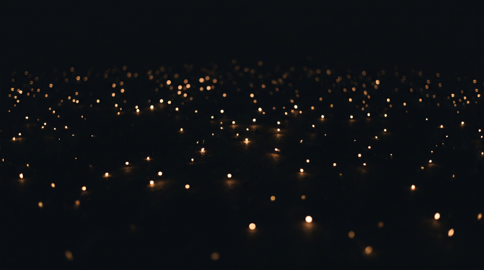 Many small points of light scattered in the dark